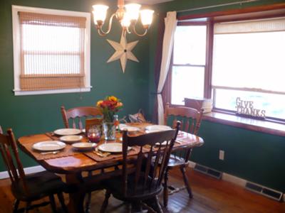 Country dining room painted a hunter green shade