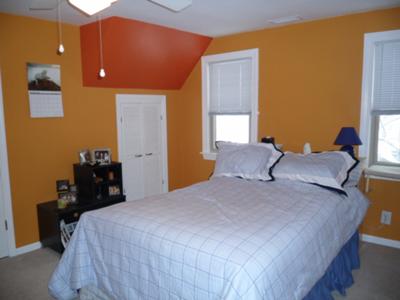Pumpkin orange walls with a dark orange accent triangle