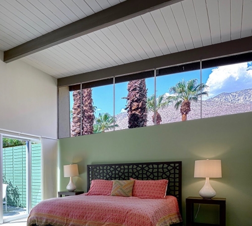 Gray bedroom with a green accent wall