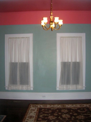 Room with sea green walls and a red ceiling