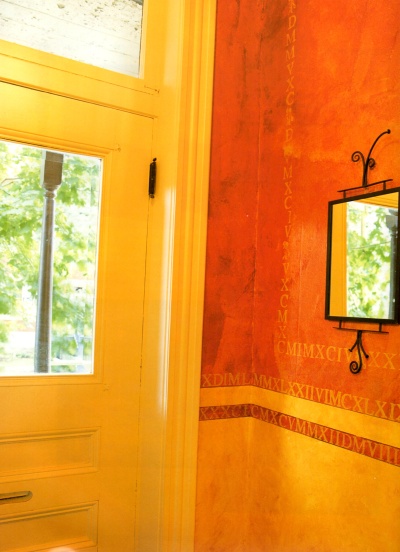Rag painted and stenciled decorative wall finish in yellow and orange