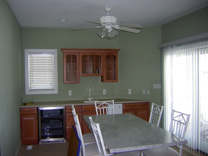 After: green paint color makes cabinetry stand out