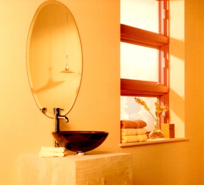 Orange bathroom window against apricot colored walls