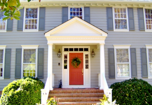 French blue painted exterior accented with a bold red front door