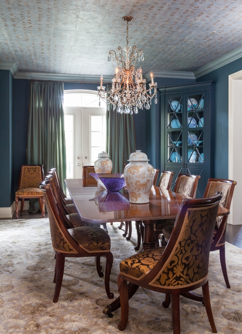 Dining room painted teal and decorated with gold and green