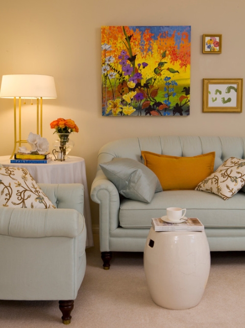 Beige living room walls with french blue furniture and bright wall art