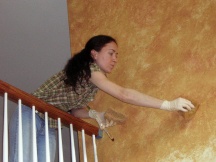 Yelena is faux painting a wall