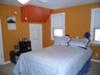 Pumpkin orange walls with a dark orange accent triangle