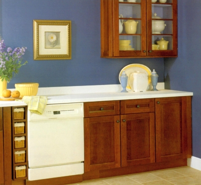 Orange stained kitchen cabinets with blue wall color