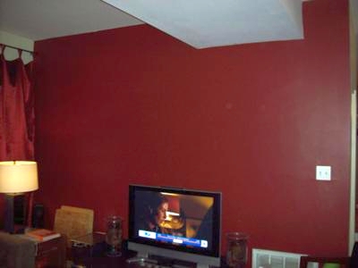 Living room wall painted a deep red color