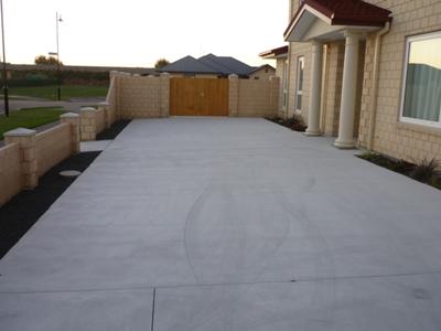 Another view of the driveway and landscaping
