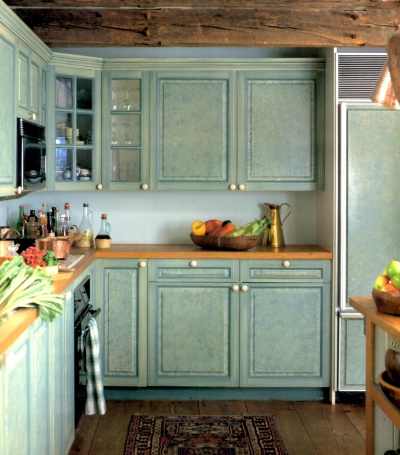 Shabby chic kitchen cabinets ragged off in butternut yellow and aqua blue for a vintage effect