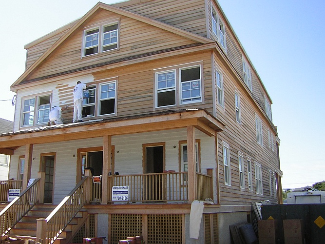 Before: bare wood siding and porch
