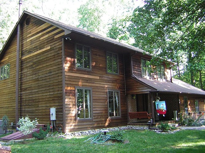 Before: blotchy looking wood siding