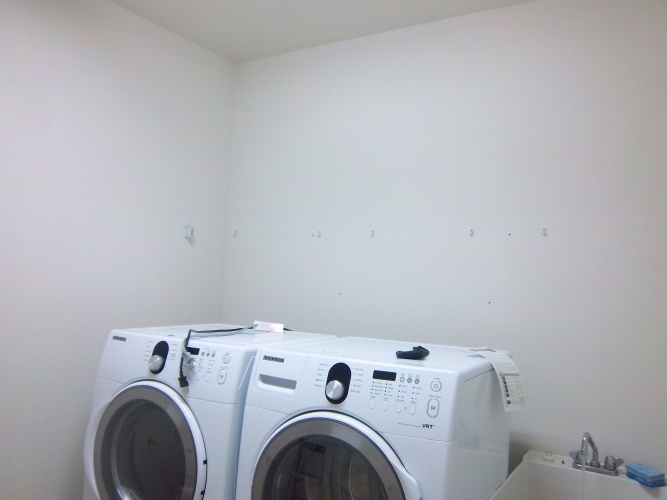 Before: boring unpainted laundry room