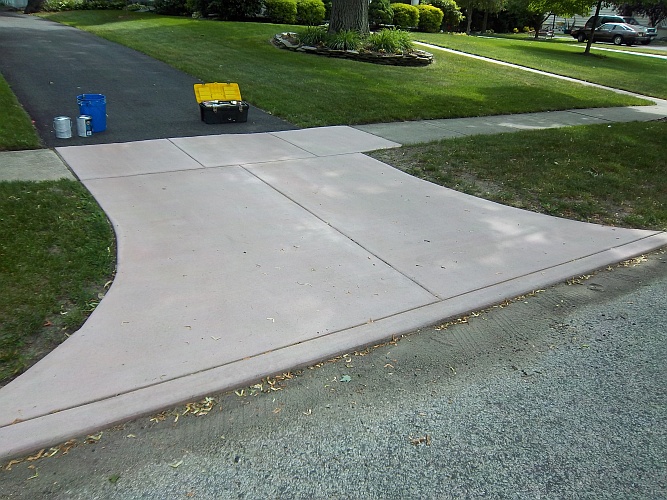 Before: pinkish concrete driveway