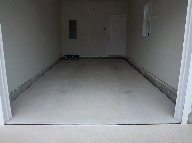 Before: bare concrete floor in garage