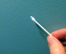 Use a small brush or Q-tip to touch up tiny imperfections