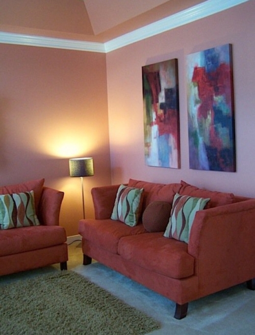 Salmon colored painted walls with green and orange accents and furniture