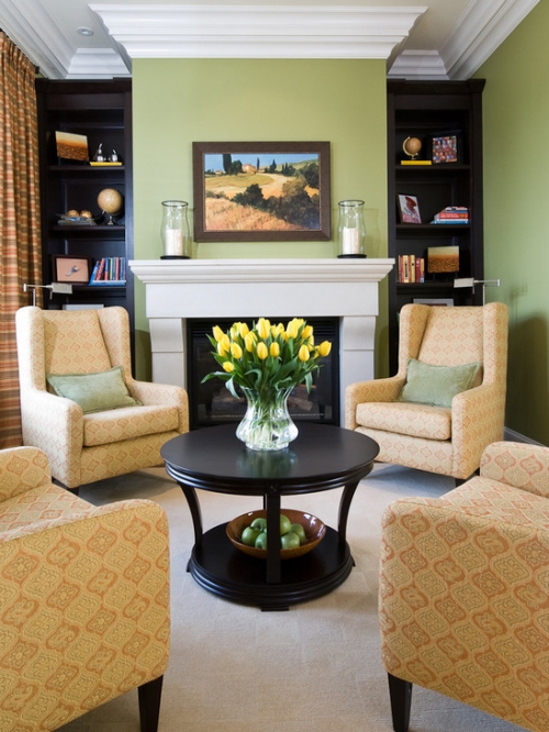 Green family room with bookcases painted black
